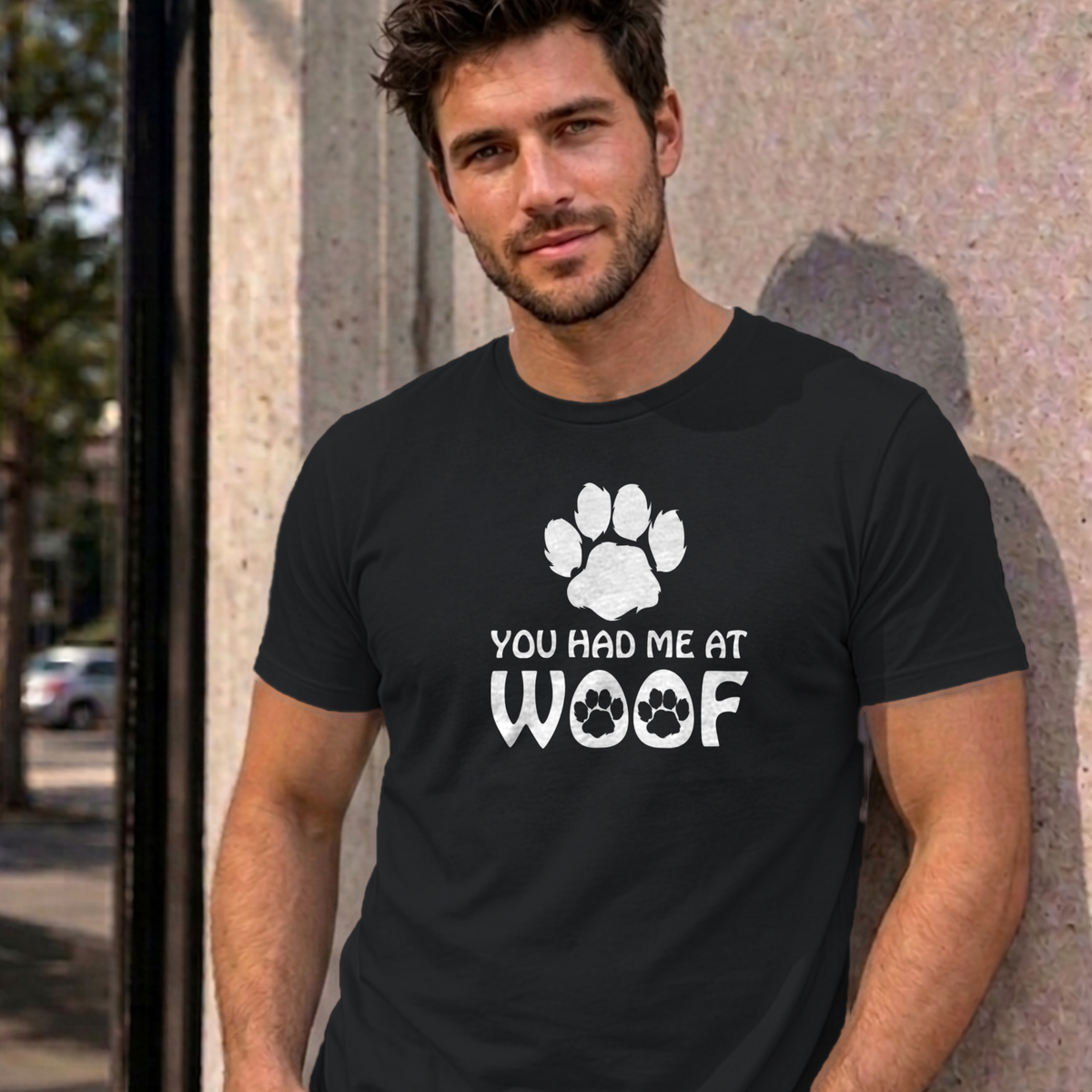 Man wearing the black You Had Me at Woof dog graphic tee