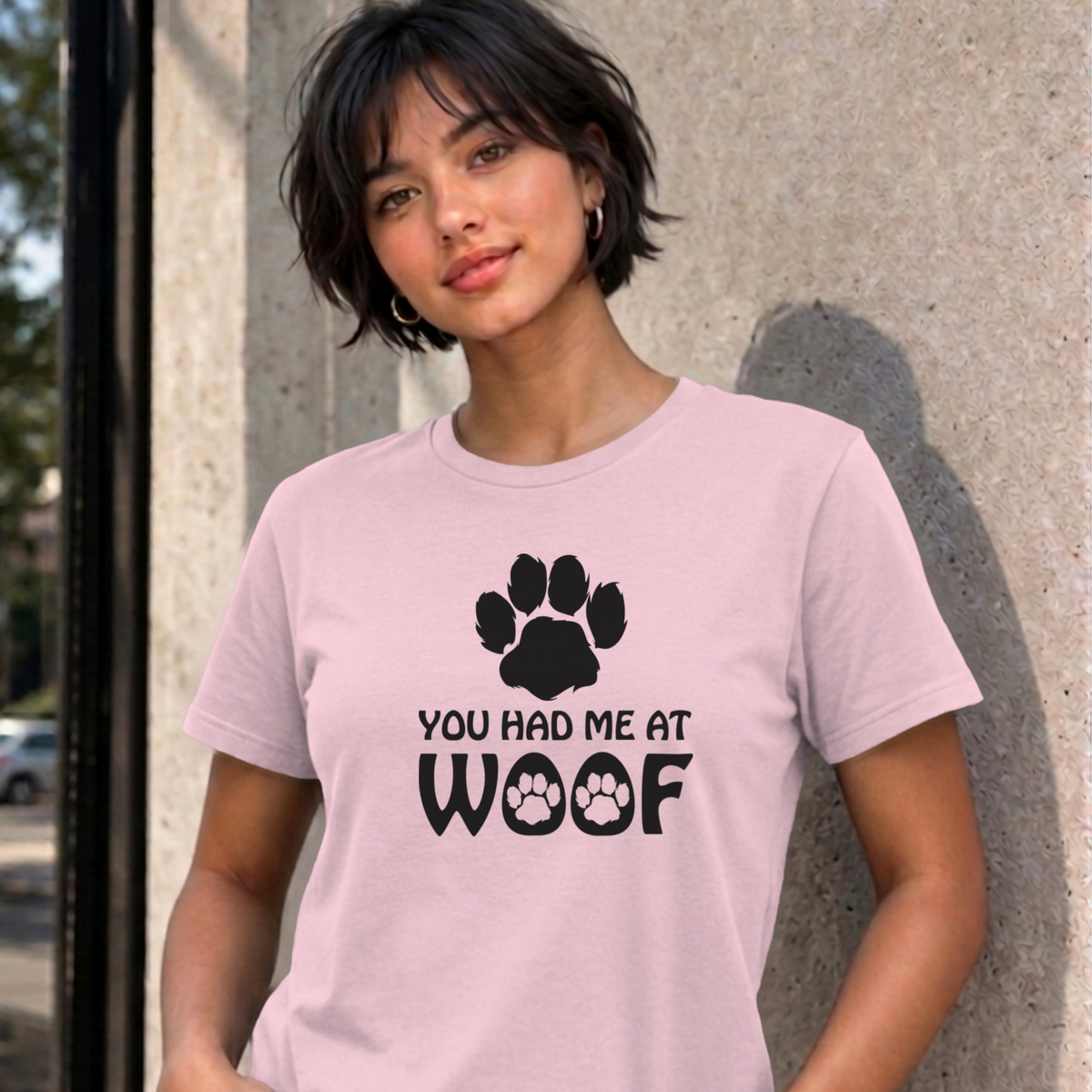 Woman wearing the light pink You Had Me at Woof dog graphic tee