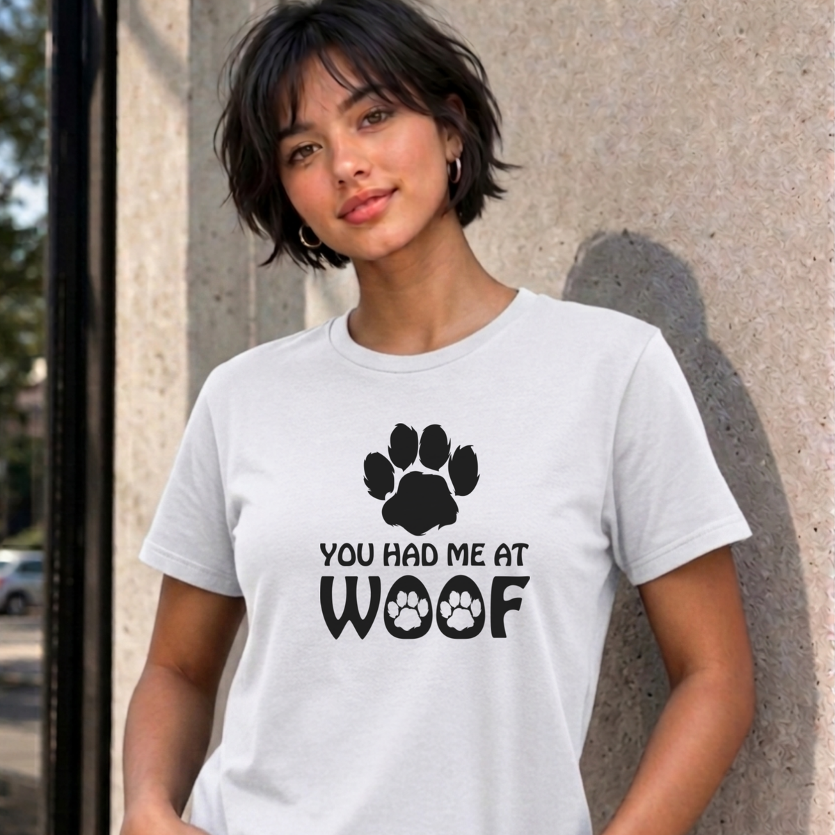 Woman wearing the white You Had Me at Woof dog graphic tee