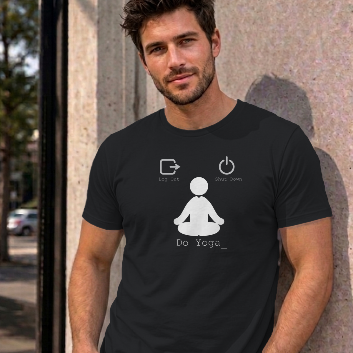 Man wearing the black Log Out Shut Down Do Yoga graphic tee