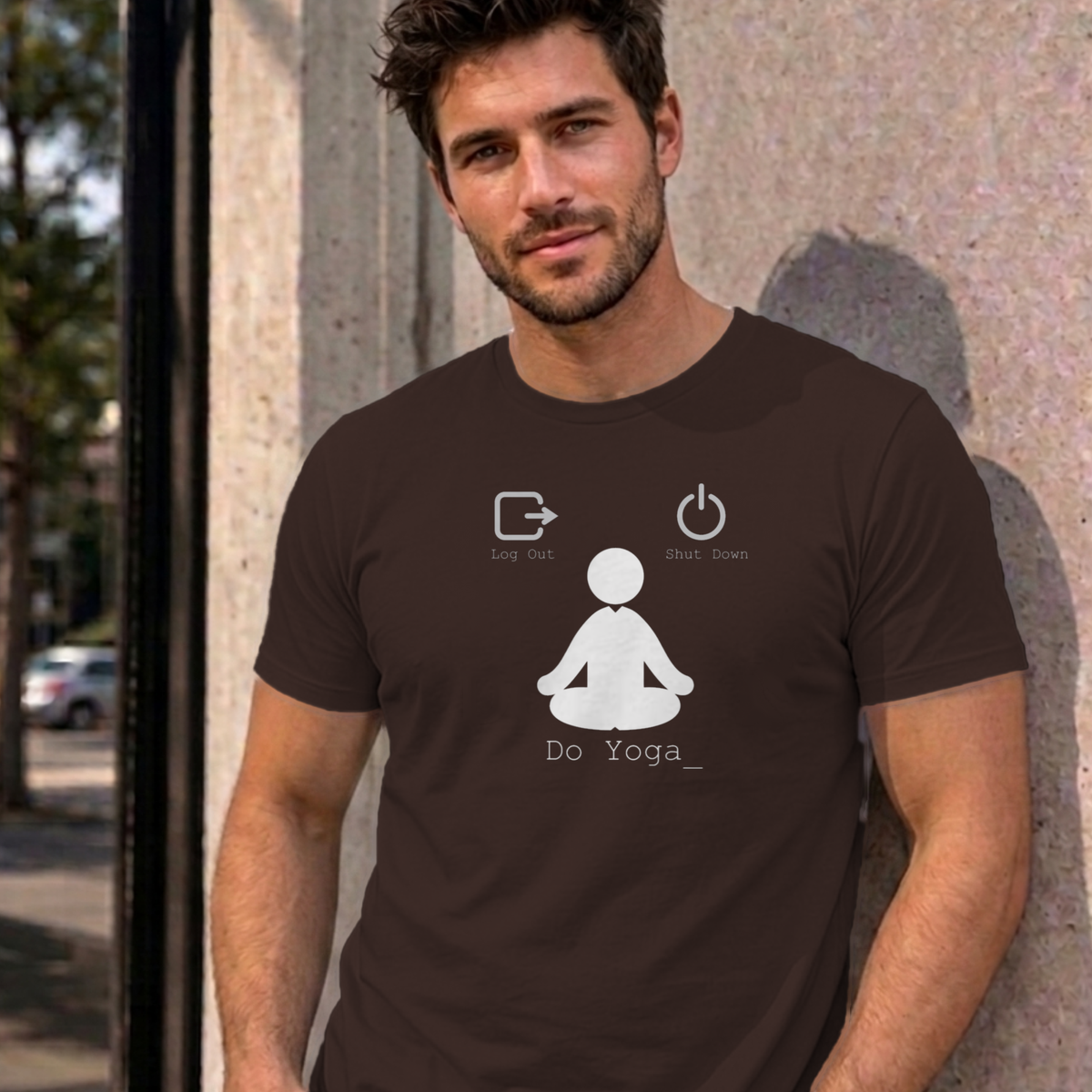 Man wearing the dark chocolate Log Out Shut Down Do Yoga graphic tee