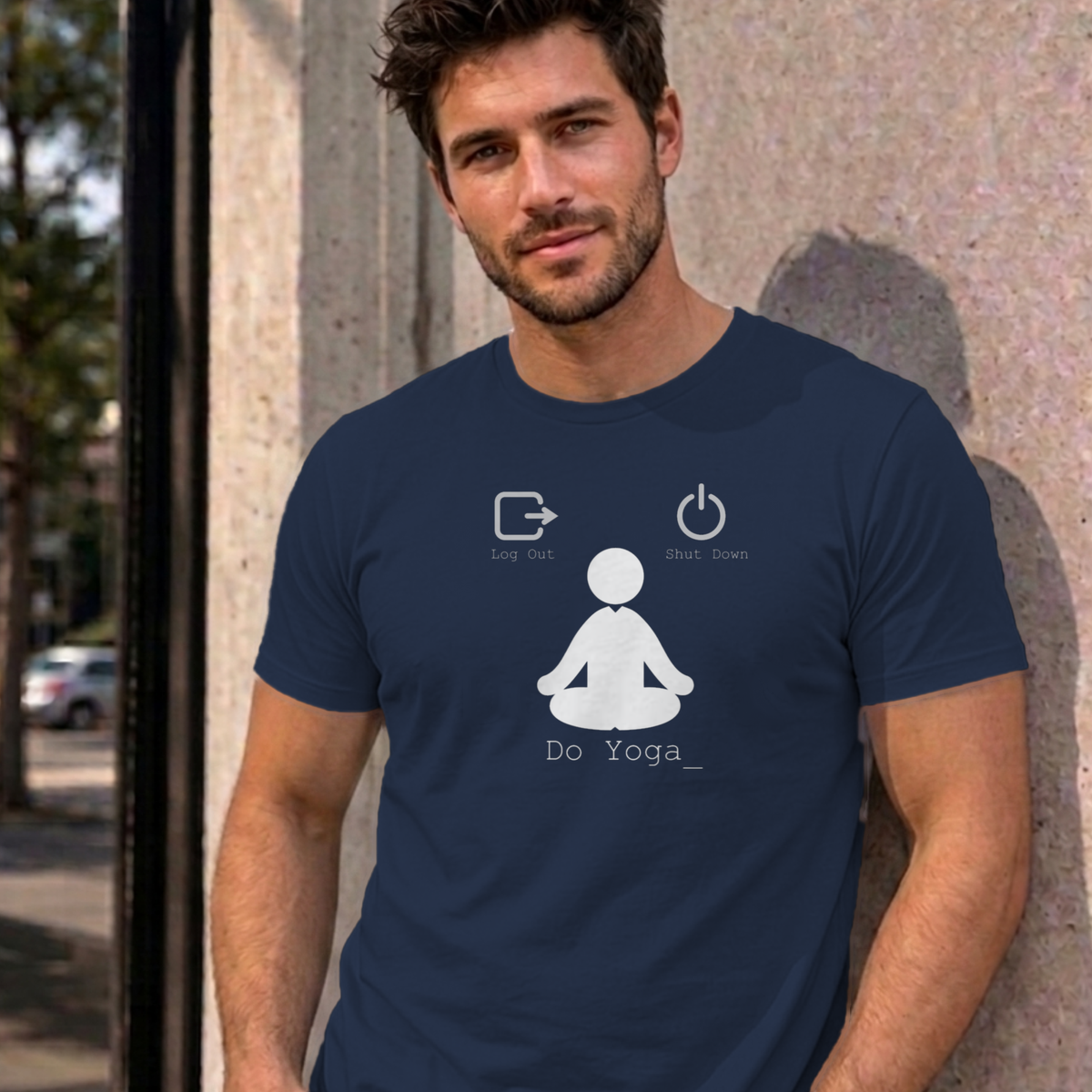 Man wearing the navy Log Out Shut Down Do Yoga graphic tee