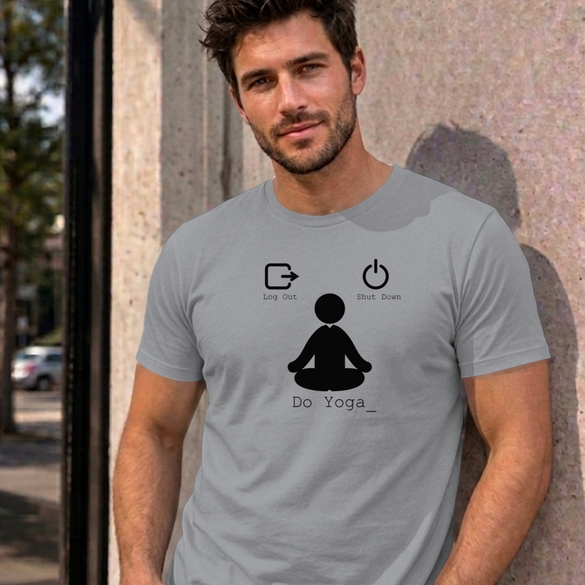 Man wearing the sport grey Log Out Shut Down Do Yoga graphic tee