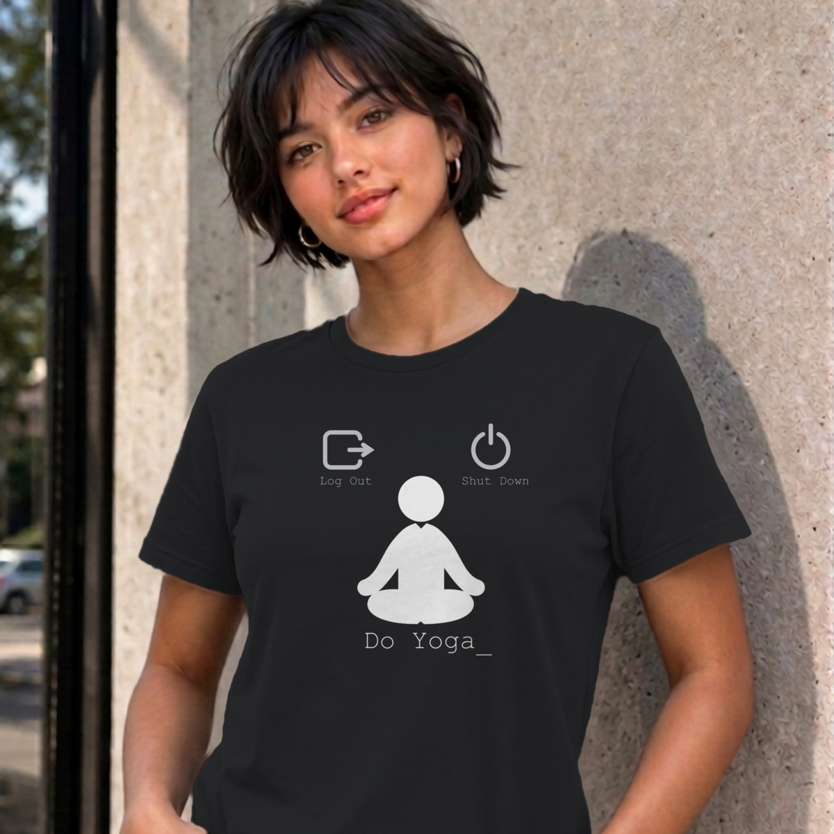 Woman wearing the black Log Out Shut Down Do Yoga graphic tee