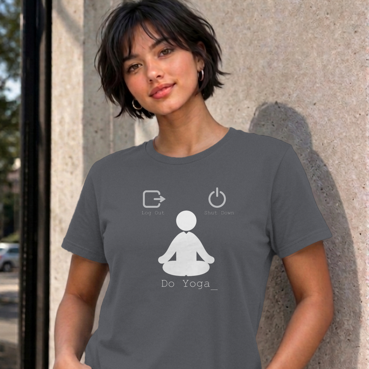 Woman wearing the charcoal Log Out Shut Down Do Yoga graphic tee