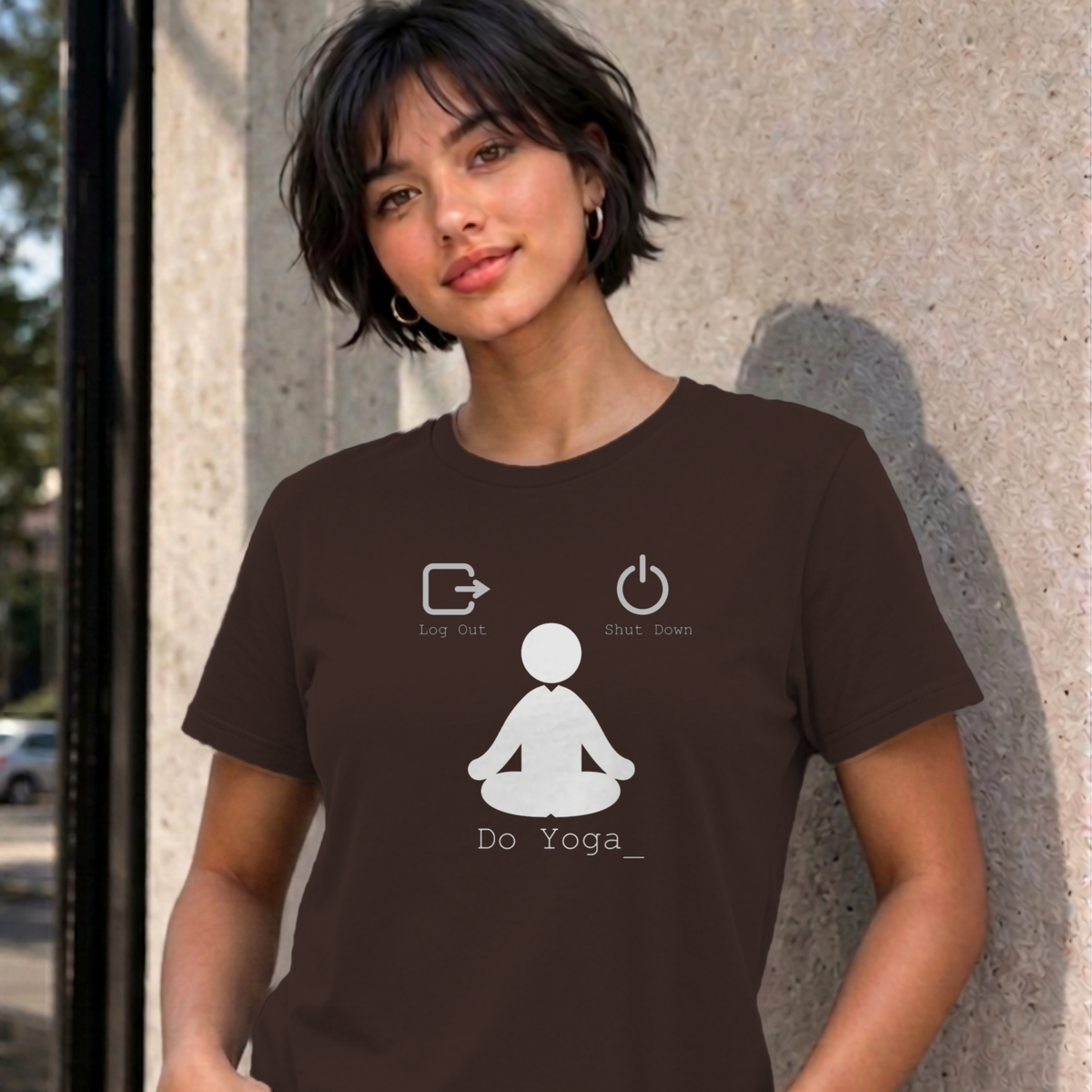 Woman wearing the dark chocolate Log Out Shut Down Do Yoga graphic tee