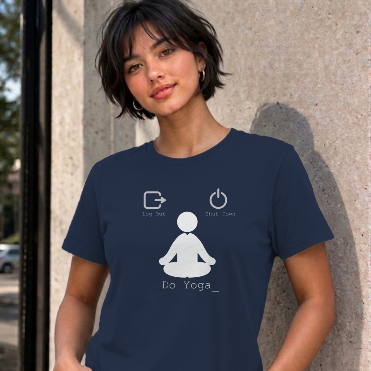 Woman wearing the navy Log Out Shut Down Do Yoga graphic tee