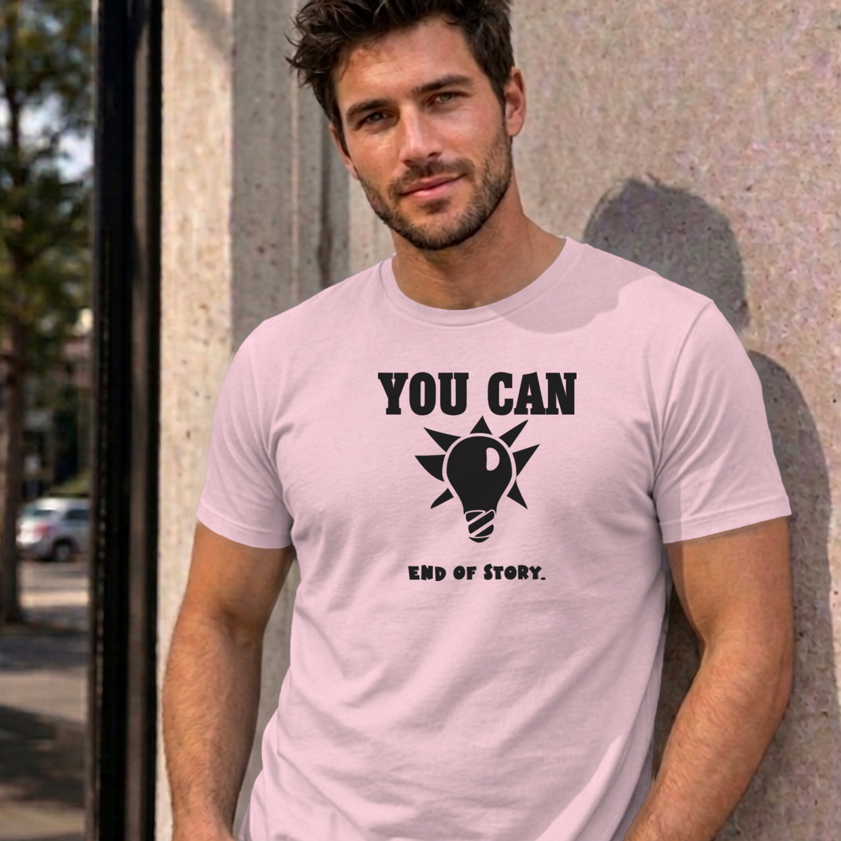 Man wearing the light pink You Can Light Bulb graphic tee